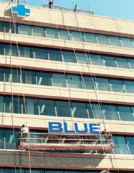 image of Alberta Blue Cross sign being installed on building